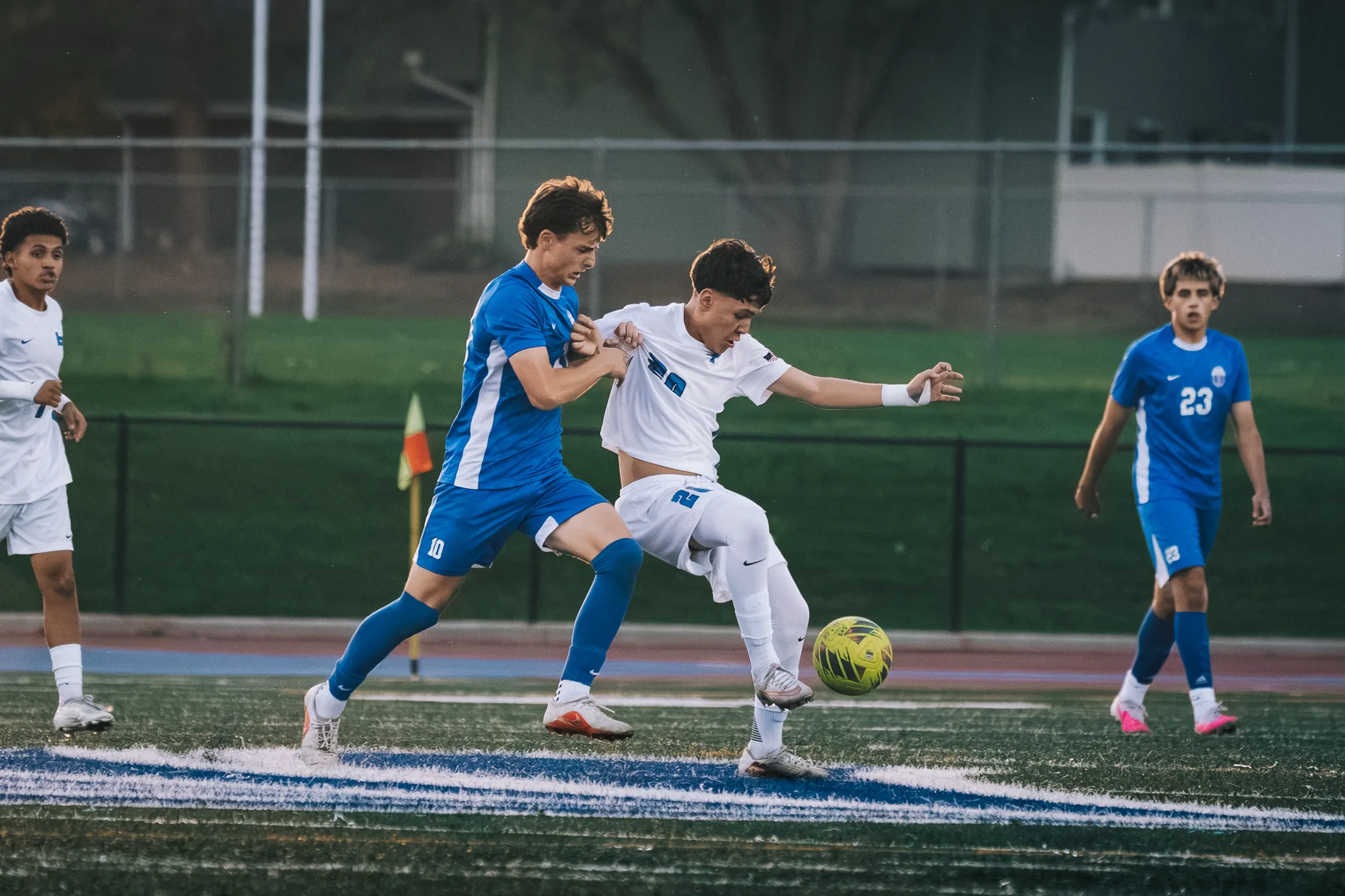 Centaurus number 10 and Longmont number 20 battle for the ball while Centaurus number 23 looks on