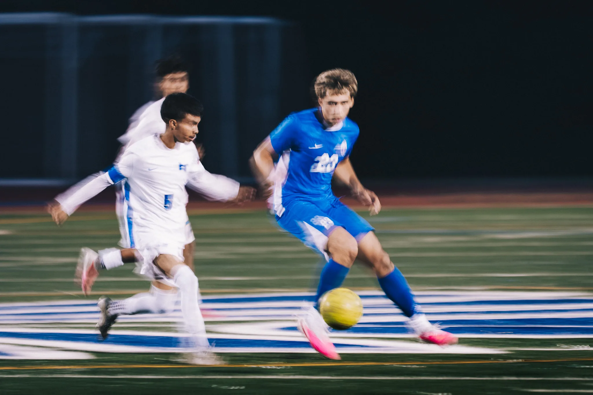 Longmont number 5 chases Centaurus number 20 as he dribbles through a blur of motion