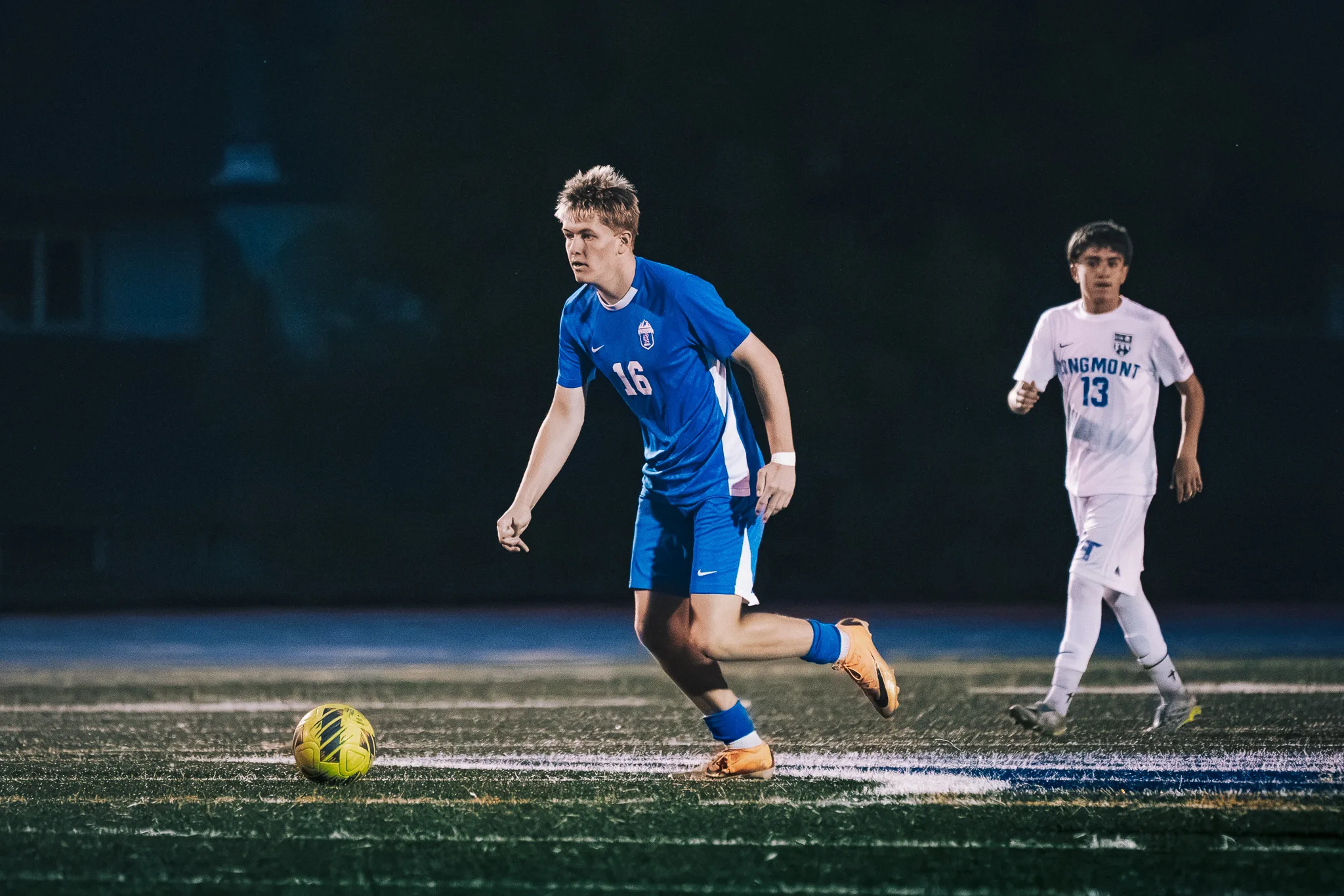 In open space, Centaurus number 16 chases the ball while Longmont number 13 follows behind