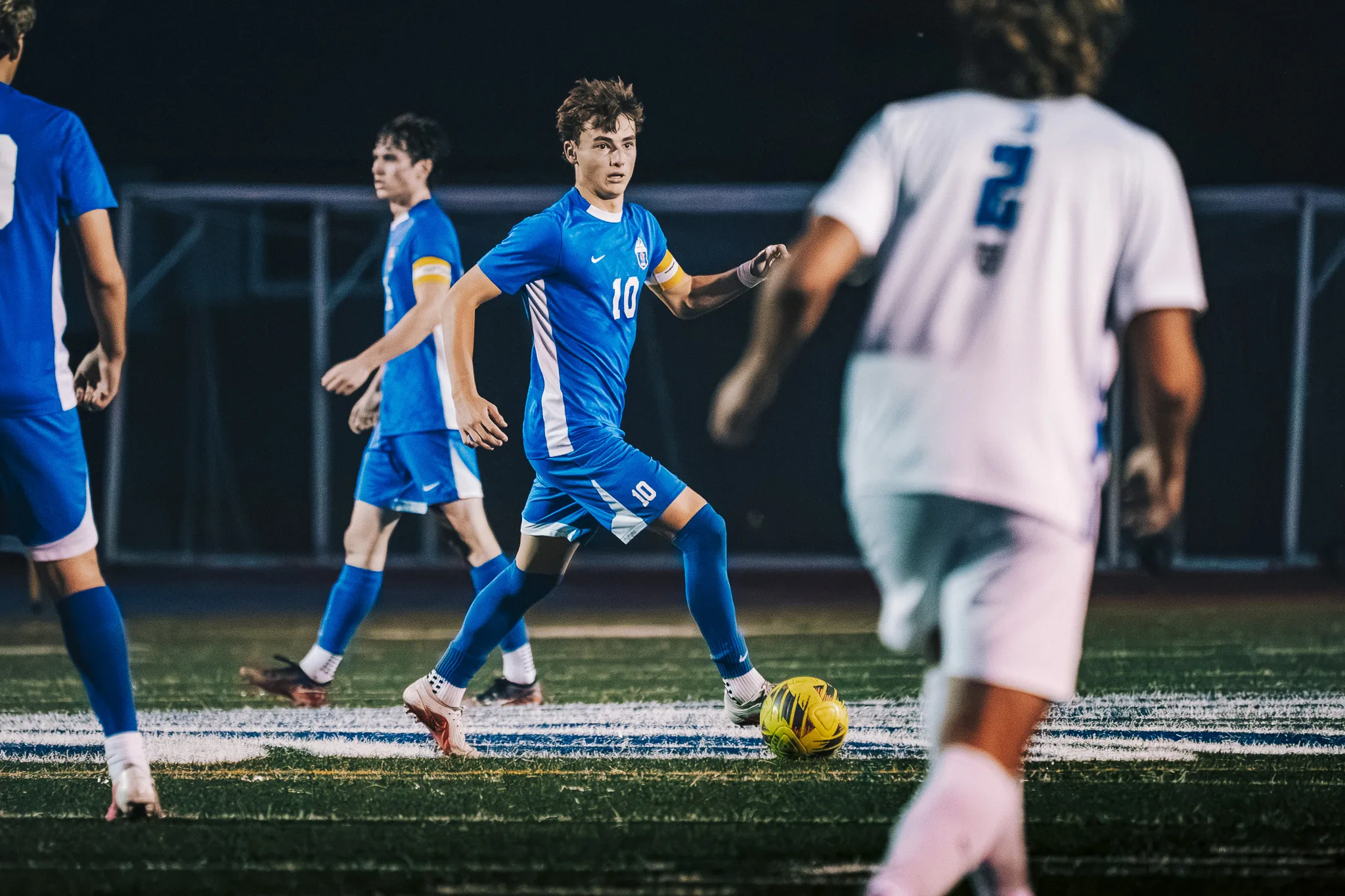 Head up, Centaurus number 10 keeps the ball at his feet as Longmont number 2 approaches in the foreground