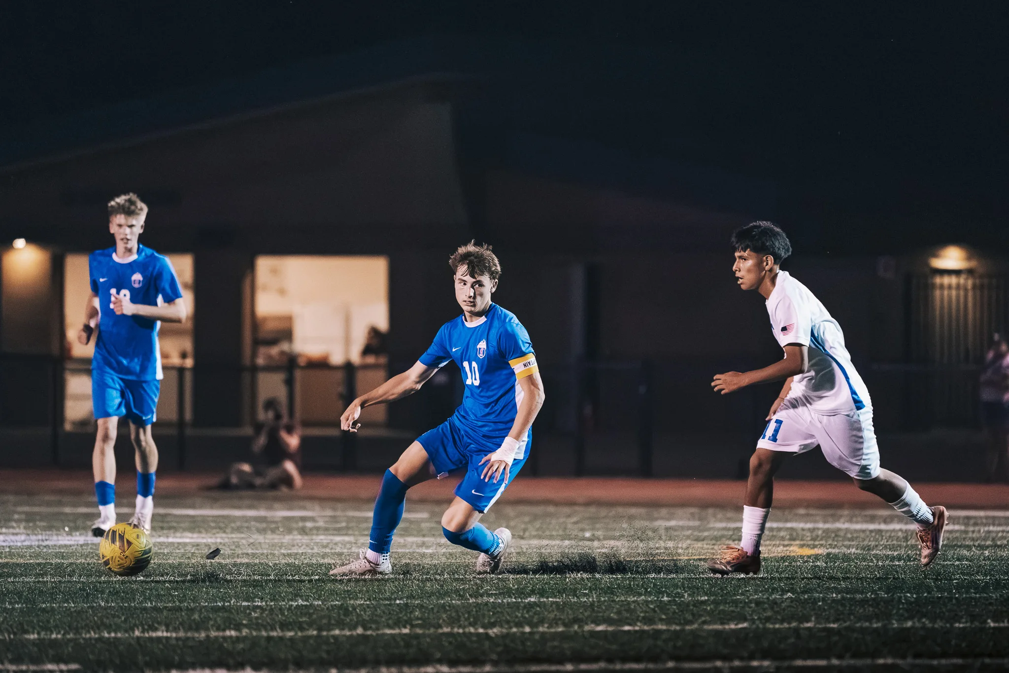 With Longmont number 11 close behind, Centaurus number 10 turns toward a teammate and the ball on the left