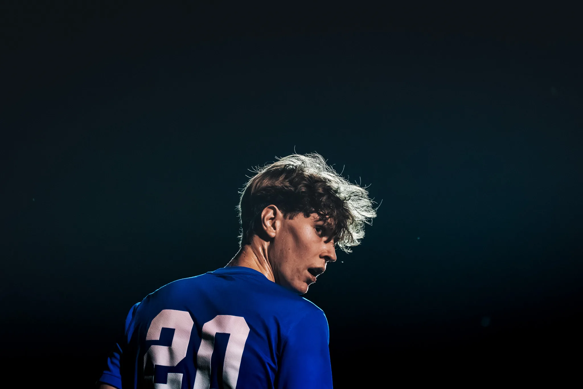 His hair catching the light from behind, Centaurus number 20 looks back over his shoulder