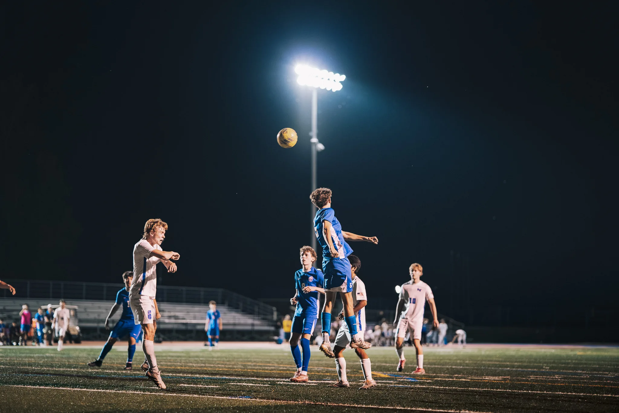 Leaping for a header, a Centaurus player rises above Longmont players and a teammate as the ball hangs high overhead