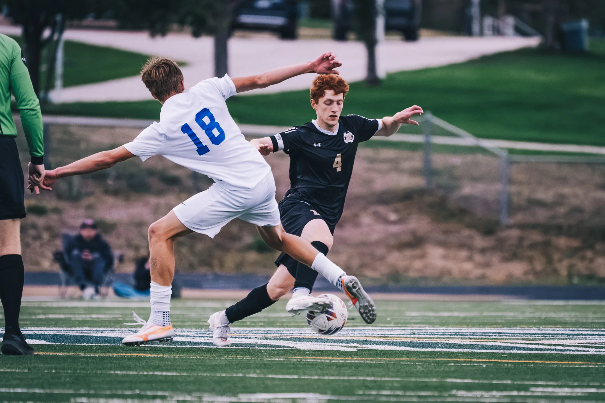 Centaurus number 18 stretches across Monarch number 4 as both reach for the ball