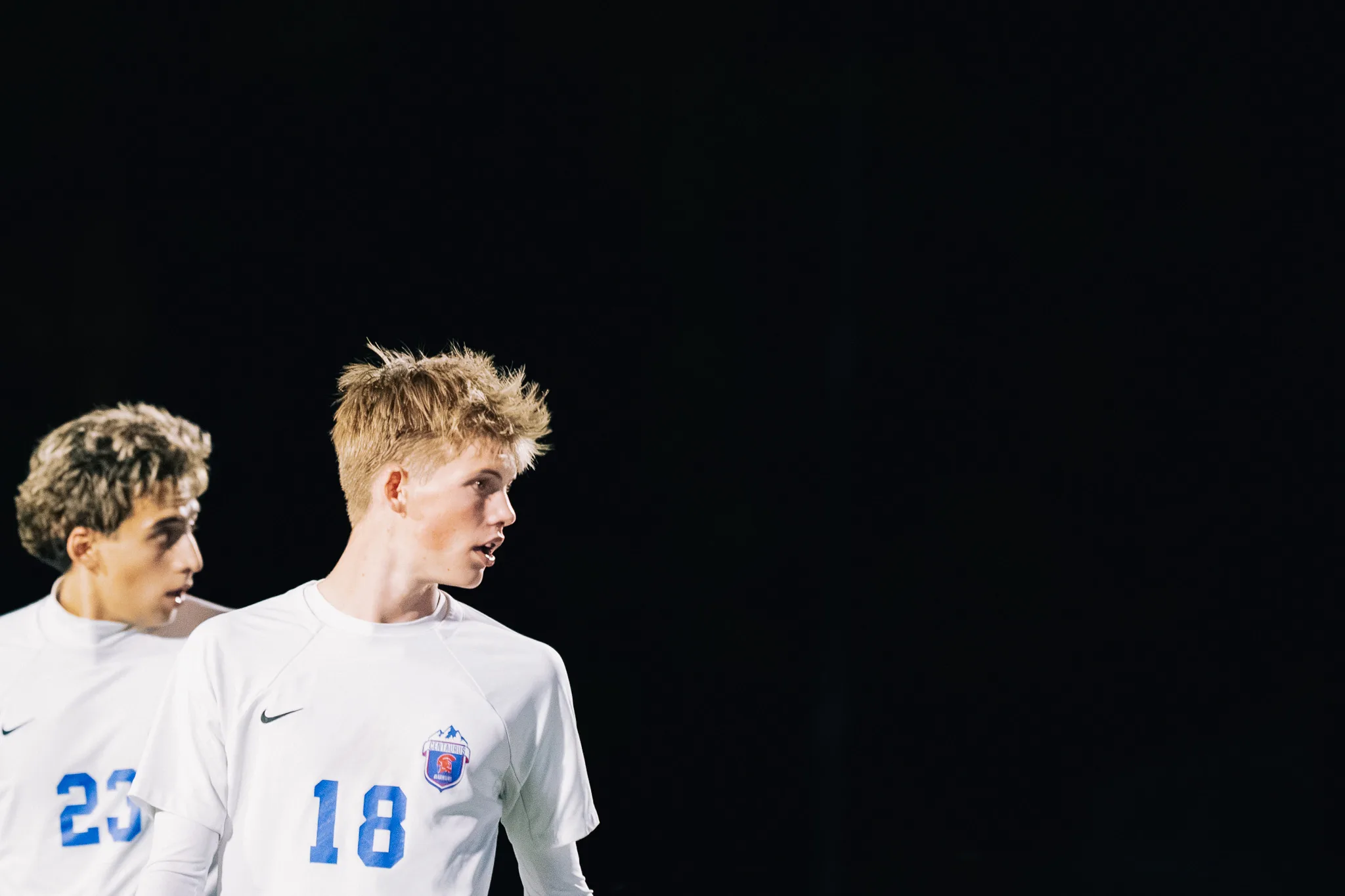 Against the dark, Centaurus number 18 looks back over his shoulder beside teammate number 23