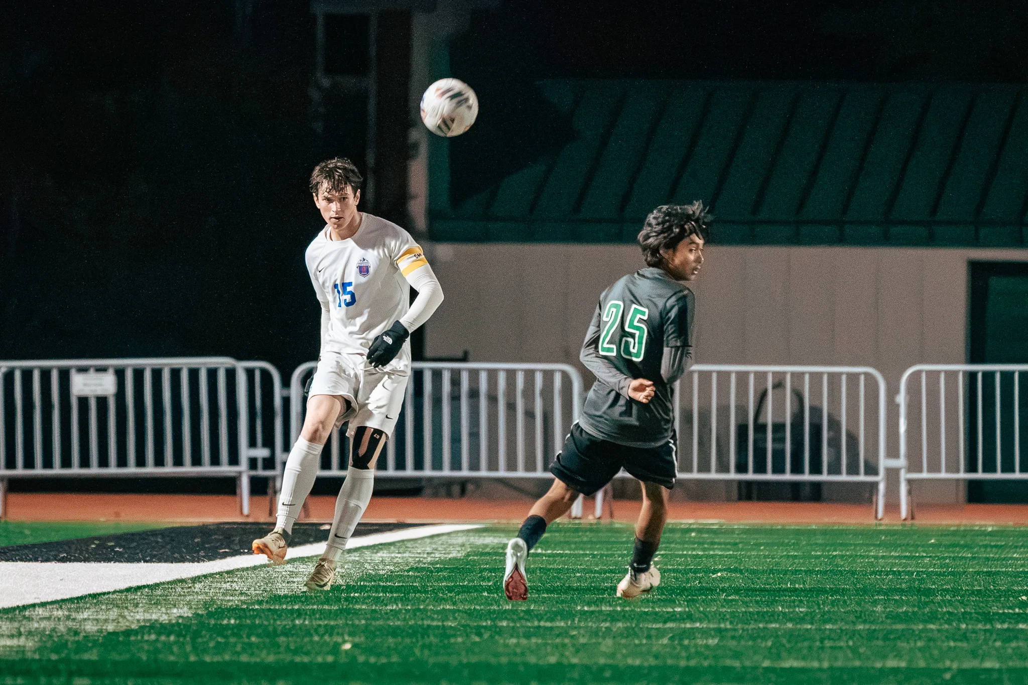 Centaurus number 15 in a yellow armband sends the ball into the air as Niwot number 25 turns to follow it