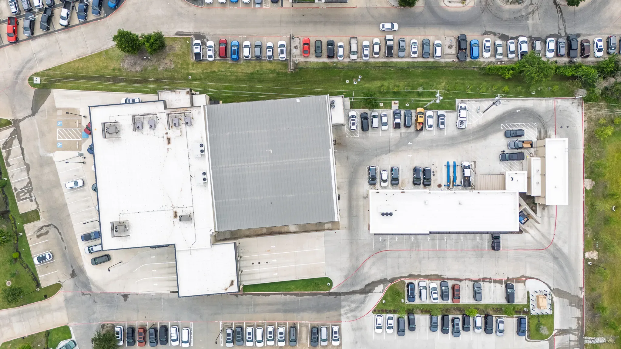 Top-down aerial of Clay Cooley Hyundai of Rockwall in Rockwall, Texas, with its roofs and inventory rows, built by The Charles Morgan Group